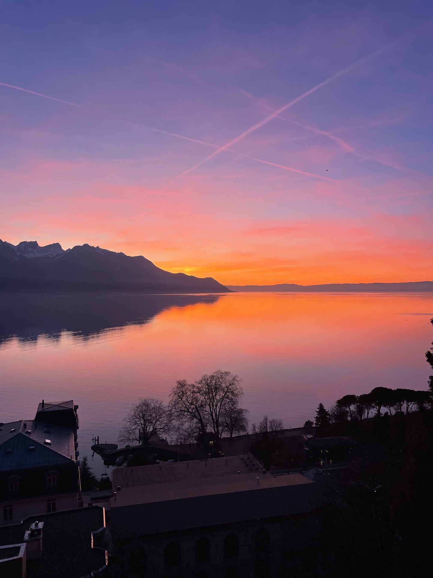 Rose-toned dusk mirrored on Lake Geneva near Montreux